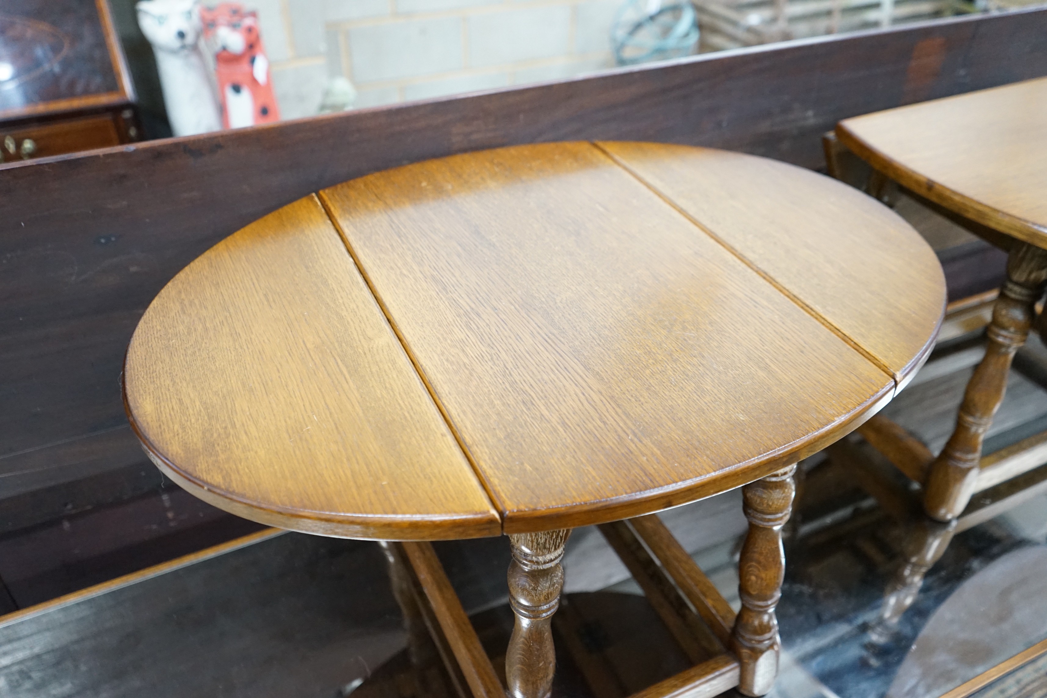 A pair of 18th century style oak drop flap occasional tables width extended 68cms, depth 50cms, height 39cms.